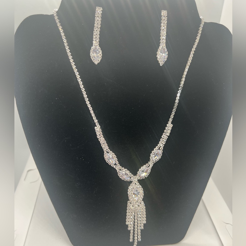 Necklace and earrings color silver.